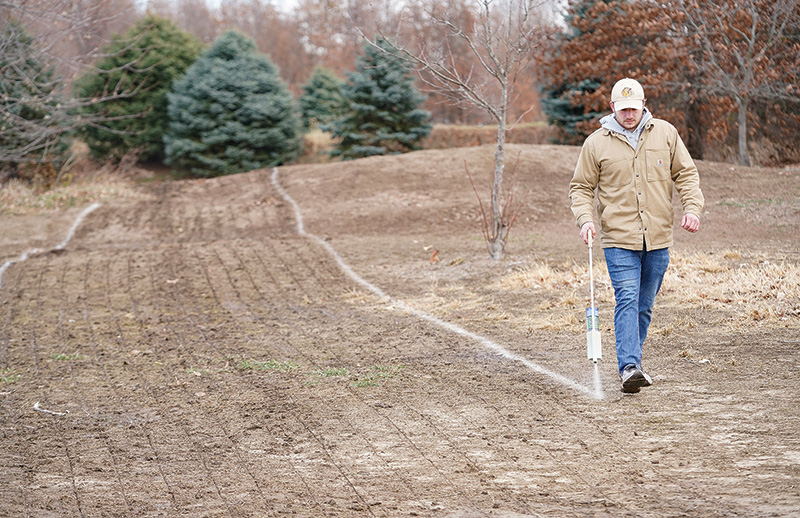 Student marking research plot