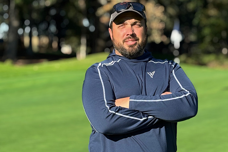 Man standing outside wearing a jacket and gray baseball cap